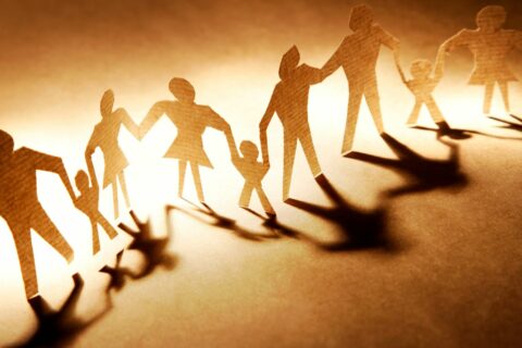 Personnages découpés en papier qui se tiennent la main